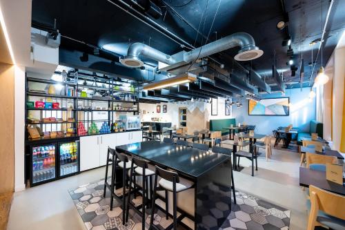 a restaurant with a black table and chairs at Staycity Aparthotels Liverpool Waterfront in Liverpool