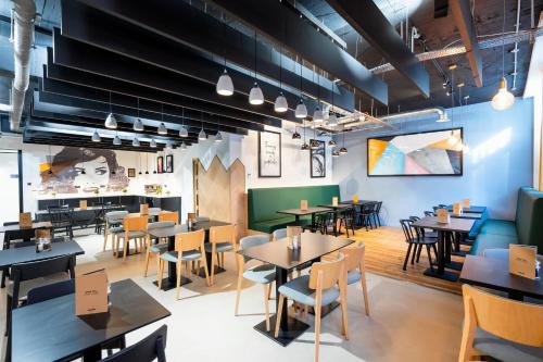 a restaurant with tables and chairs and a cafeteria at Staycity Aparthotels Liverpool Waterfront in Liverpool