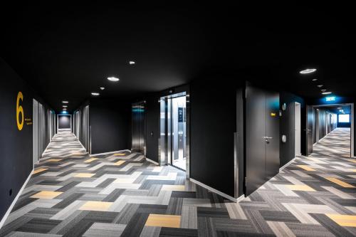a hallway of an office building with a checkered floor at Staycity Aparthotels Liverpool Waterfront in Liverpool