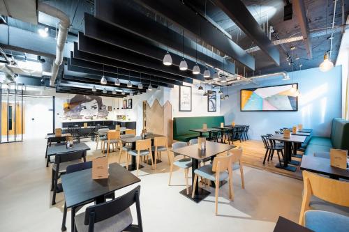 a dining room with tables and chairs in a restaurant at Staycity Aparthotels Liverpool Waterfront in Liverpool