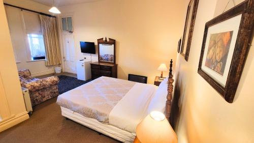 a bedroom with a bed and a living room at Leura House in Leura