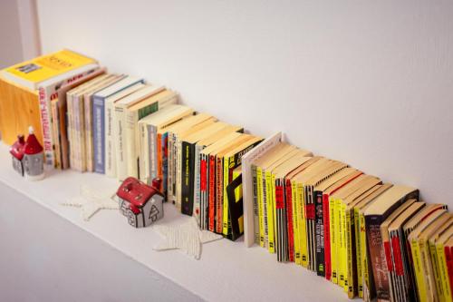 a row of books sitting on a shelf at Ospizio La Veduta in Bivio