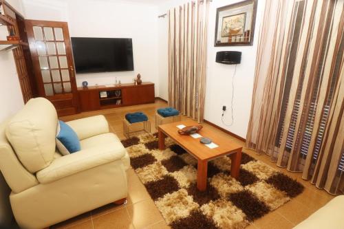 a living room with a couch and a coffee table at Casa Bela Vista by Gerês Casas in Geres