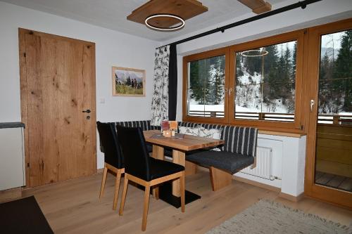 a dining room with a wooden table and chairs at ZIRBENNEST Martha in Biberwier