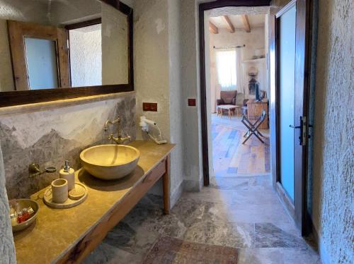 a bathroom with a sink and a mirror at Seki Cave Suites in Goreme