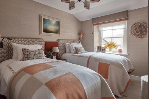 a bedroom with two beds and a window at The Little Cottage in Chapel Stile