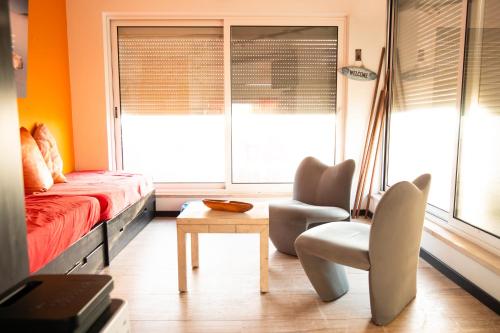 a bedroom with a bed and a chair and a table at Beach Apartment in Faro