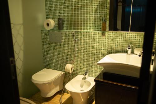 a small bathroom with a toilet and a sink at Beach Apartment in Faro