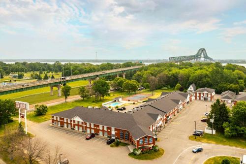 an aerial view of a building with a bridge in the background at Les Suites de Laviolette Ascend Hotel Collection in Trois-Rivières