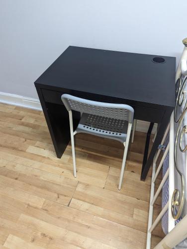 a black desk with a chair in front of it at Oldham town centre rm02 in Oldham