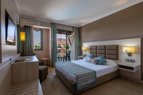 コナクリにあるPalmeras Beach Hotel Ultra All Inclusiveのベッドとバルコニー付きのホテルルーム