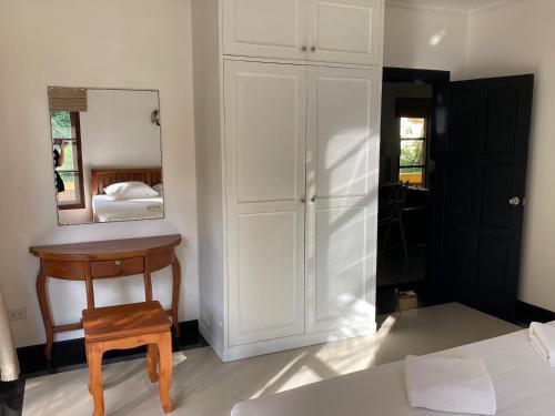 a bedroom with a bed and a mirror and a chair at Samui Green Life in Bophut 