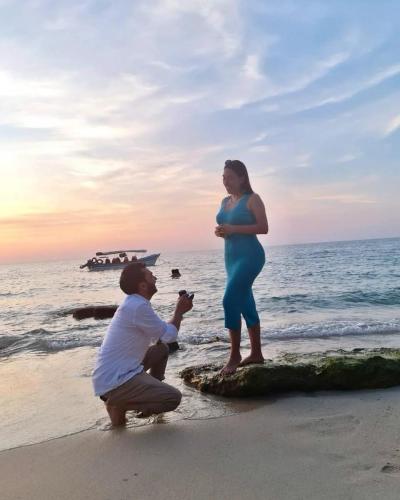 a man and a pregnant woman standing on the beach at Cristal Blue Barú in Baru