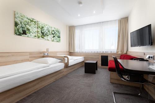 Posteľ alebo postele v izbe v ubytovaní Hotel Koruna
