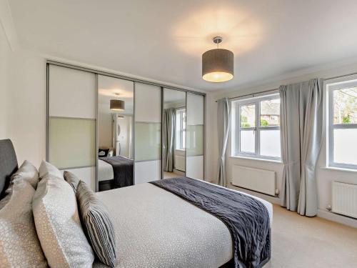 a bedroom with a large bed and windows at 1 bed property in Harrogate North Yorkshire HH097 in Harrogate