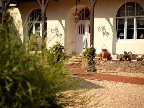 a house with a person sitting on the porch at PARK VILLA zentral am Mittelrhein Zimmer&Apartments Self check in Aparthotel in Boppard