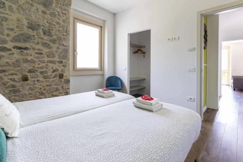 Postel nebo postele na pokoji v ubytování Ledro Lake Suites