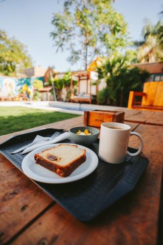 a plate of bread and a cup of coffee on a table at Gorilla Hostel in Mendoza