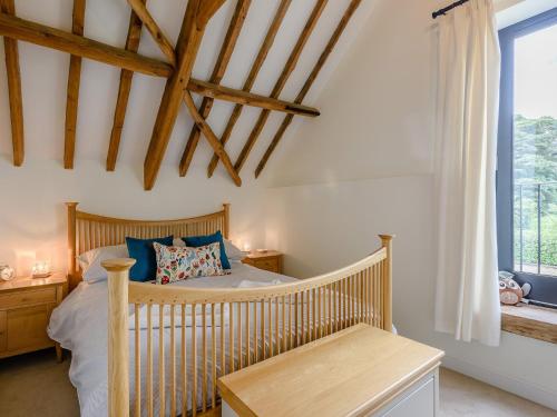 a bedroom with a crib and a window at 3 bed in Winterton-on-Sea 77582 in Hickling