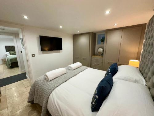 a bedroom with two beds and a flat screen tv at Lilimae Barn in Ashbourne