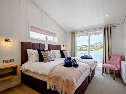 1 dormitorio con 2 camas y ventana grande en 2 bed in Castle Douglas 77837 en Auchencairn