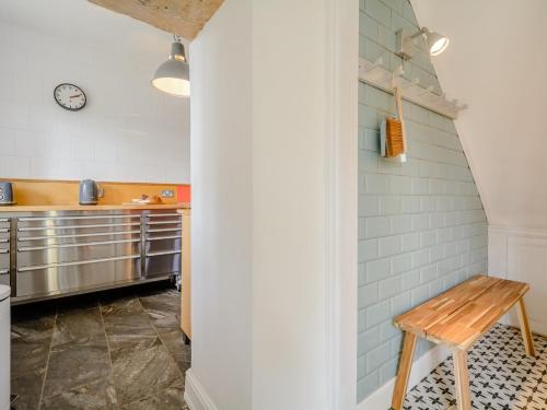 a kitchen with a wooden bench in the corner at 3 Bed in Nailsworth 78968 in Nailsworth