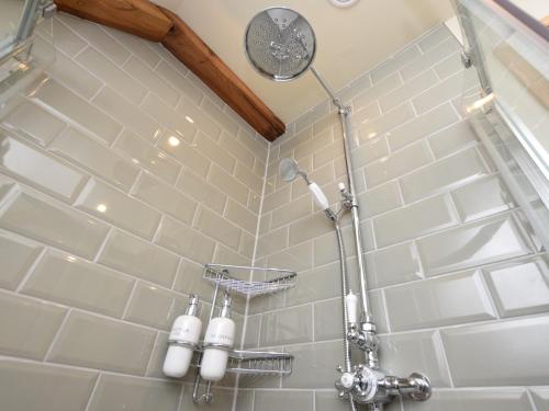 a shower with white tiled walls and lights in a bathroom at 2 Bed in Peebles 76383 in West Linton