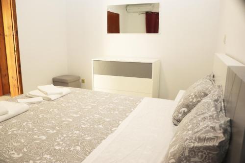 a bedroom with a bed with a gray and white comforter at Casa Bela Vista by Gerês Casas in Geres