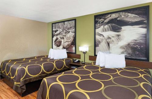 a hotel room with two beds and a large picture at Super 8 by Wyndham Kingsport in Kingsport