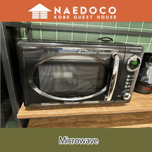 a microwave oven sitting on top of a counter at LN14 なえどこハウス 2023年末オープン!三宮新神戸徒歩10分! 2LDK house in Fukiaichō