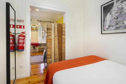 a bedroom with a bed and a living room at WHome Central Alfama Hideaway perfect to explore Lisbon in Lisbon