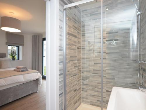a bathroom with a shower with a glass door at 3 Bed in Westward Ho 76533 in Northam