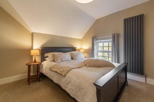 a bedroom with a large bed and a window at Foxhill House in South Creake