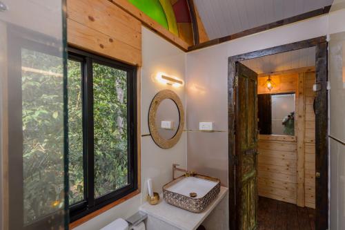uma casa de banho com uma janela e um WC. em Nirvana Hill Resort em Curtorim