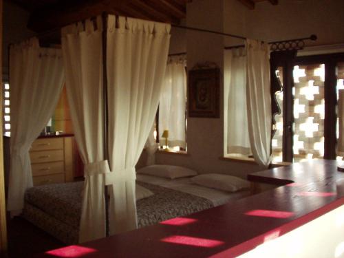 a bedroom with two beds with white curtains and a table at Il Cigliere your holiday home in the heart of Tuscany in Florence
