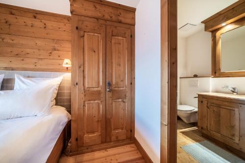 a bedroom with a bed and a toilet and a sink at Ayous Verbier - BY EMERALD STAY in Verbier