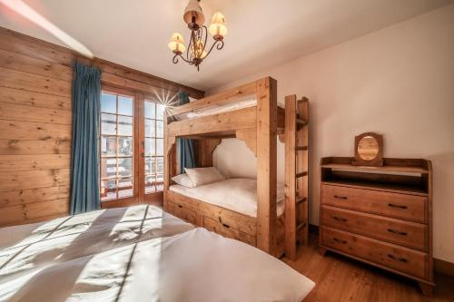a bedroom with a bunk bed and a dresser at Ayous Verbier - BY EMERALD STAY in Verbier