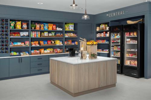a grocery store with a counter and shelves of food at Home2 Suites Orlando Southeast Nona in Orlando