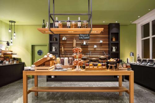 a store with a table in the middle of a room at Vienna House Easy by Wyndham Landsberg in Landsberg am Lech