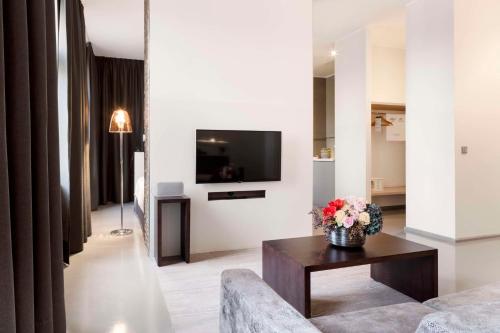 a living room with a couch and a table with flowers at Lux 11 Berlin-Mitte in Berlin