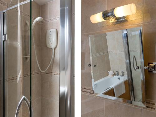 a bathroom with a shower with a sink and a mirror at 3 Bed in Brecon Town BN037 in Llanspyddid