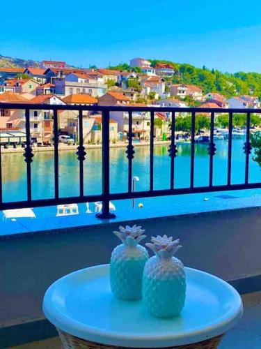 a table on a balcony with a view of the water at Harbour View House in Zaton