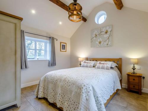 a bedroom with a bed with a white bedspread and a window at 2 Bed in Audlem 81106 in Audlem