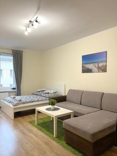 a living room with a couch and a table at 26 Gdynia Centrum - Apartament mieszkanie dla 4 osób in Gdynia