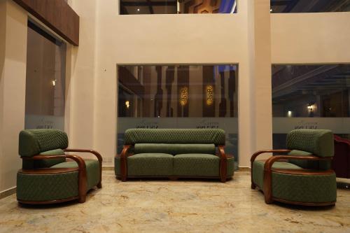two chairs and a couch in a lobby at HOTEL VKJ INN Aluva in Alwaye