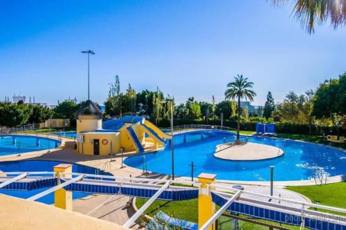 a large pool with a slide at a water park at Jupiter2 Moderno estudio Parque La Paloma in Benalmádena