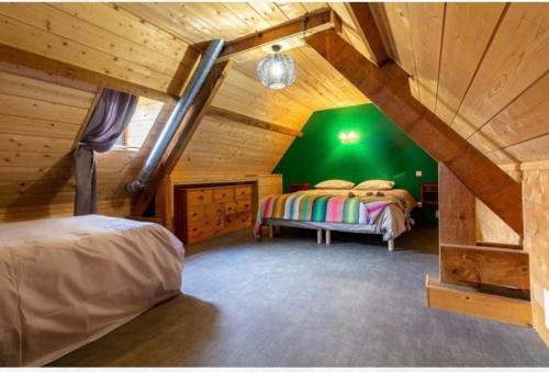 a bedroom with two beds in a attic at Villa de Lurp panorama spa 12 pers in Saint-Pastous
