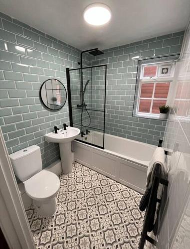 a bathroom with a toilet and a sink at 4 Mellors Court in Warwick