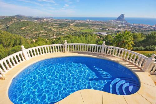 a swimming pool on a balcony with a view of the ocean at Villa Lehman - PlusHolidays in Calpe