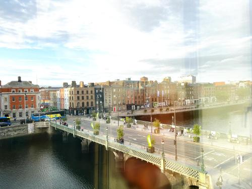 a bridge over a river in a city at Modern Apartment at Temple Bar with River View in Dublin